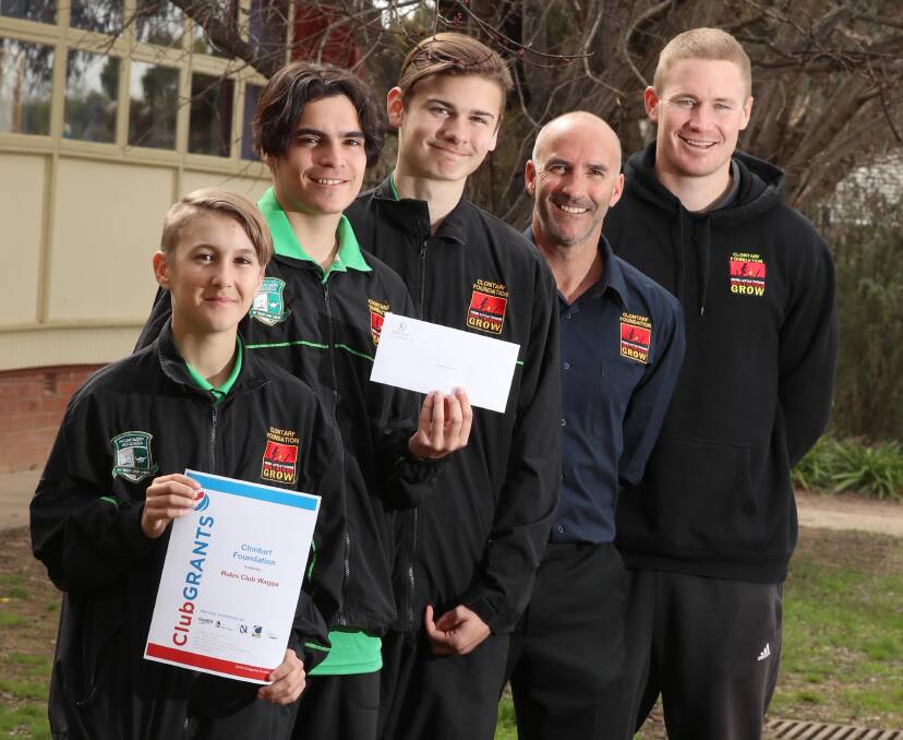GRANT GRINS: Clontarf Foundation's Dylan Hayward 14, Cameron Palmer 15, Yestin Hall, 16, director Pat Edmunds and operations officer Nick Skinner. Picture: Les Smith