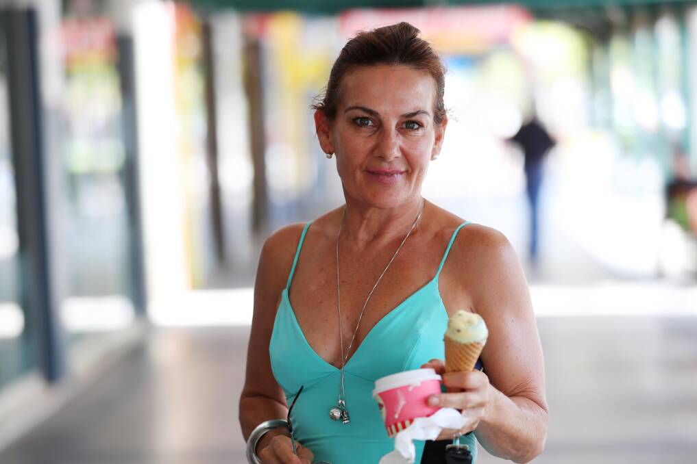 Caroline Pledger from the Gold Coast cools down with ice cream. Picture: Emma Hillier