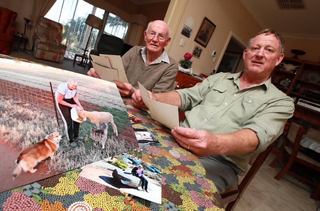 IN MEMORY: Jo Kuiper's father, Dal Eisenhauer (left) and husband Rob Kuiper at home in Junee, look through photos from Jo's life. Picture: Les Smith