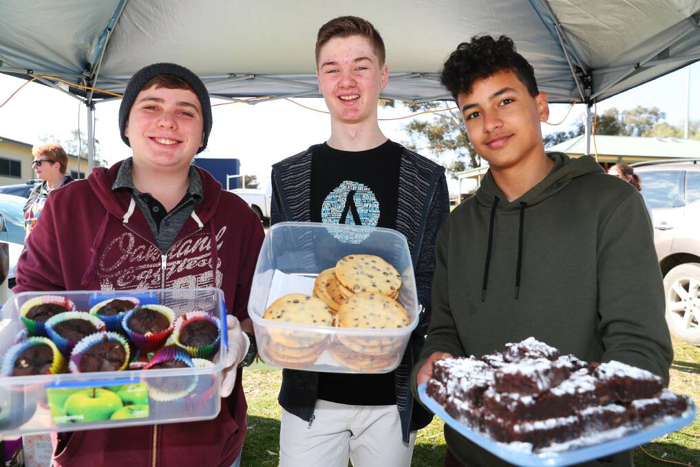 COOKING FOR CAMP: students Ethan Smith, Michael Nixon and Youhanna Wahba selling baked goods at the Markets By The Lake to fundraise for their journey to Space Camp. Picture: Emma Hillier