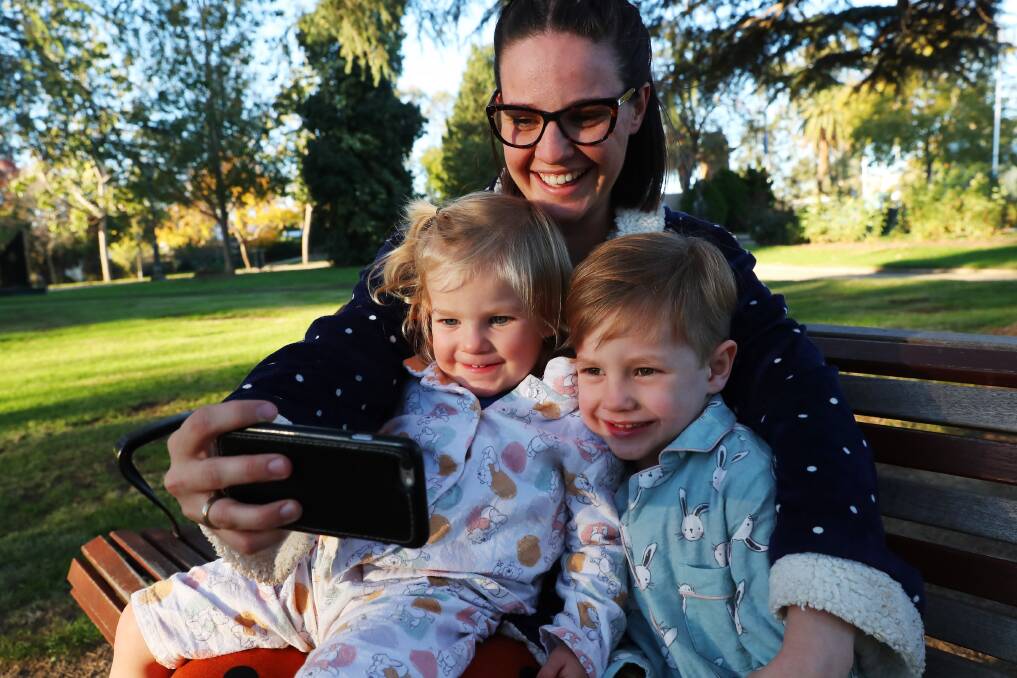 TOGETHER: Jessica Condell with two-year-old daughter Alice, and four-year-old son Fletcher in pyjamas to FaceTime family. Picture: Emma Hillier