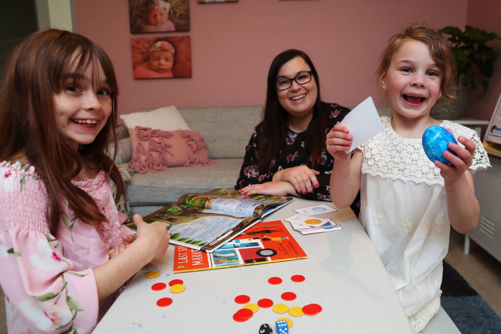 LEARNING FROM HOME: Lori aged eight and Livinnia aged 6, with mother April Nagle during their at-home lessons. Picture: Emma Hillier