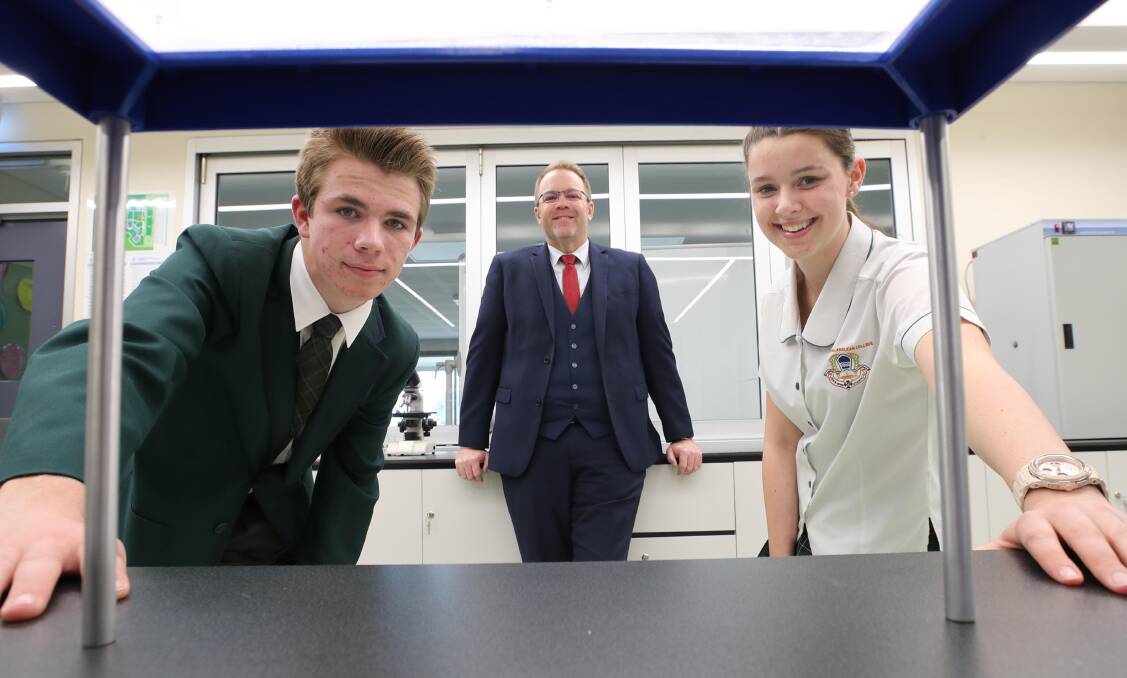IN THE LAB: Principal Paul Humble with Liam Whiting and Charlotte Collins who have enrolled in the first International Baccalaureate course.