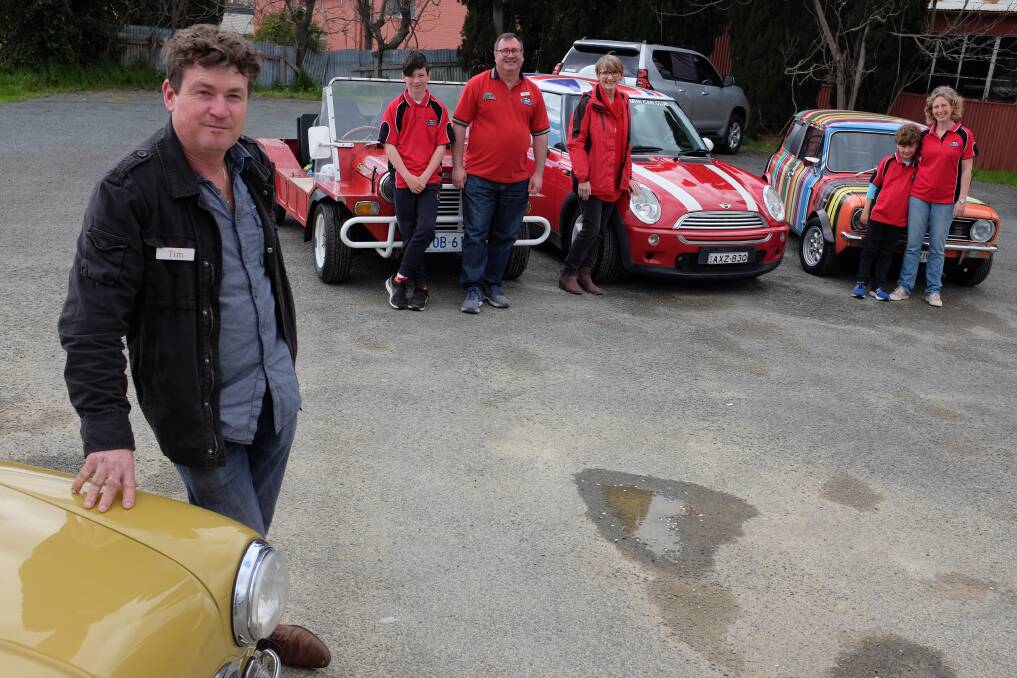 TIME WARP CARS: Riverina Mini Car Club president Tim Peachey (left) and members (from left) Charlie, 11, and Scott Yates, Judy Case, Patrick, 9, and Adele Yates, with some of the Minis that will be travelling across the Riverina this weekend. Picture: supplied