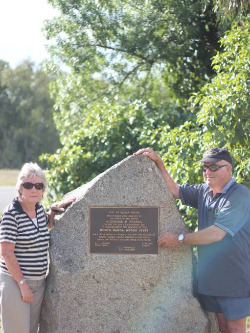 WATER WOES: Cheryl and Geoff Conway with the plaque establishing that a 9.9metre river should only breach the levee once in 20 years. Picture: Emma Horn