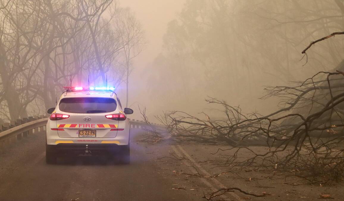 DUNNS ROAD FIRE: Emergency vehicles comb through the aftermath of fires between Wondalga and Batlow on January 5. Picture: Les Smith