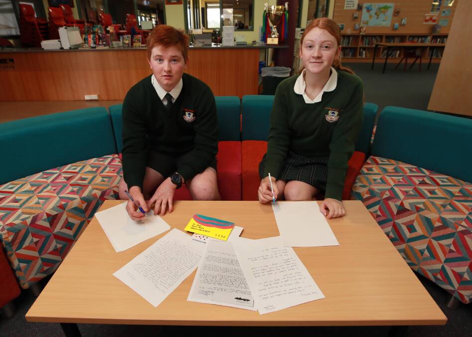 LETTERS OF NOTE: Paddy Malmo and Isabel Brown, both 16, set to writing to their pen pals across the city. Picture: Les Smith