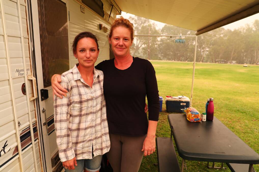 NOTHING WITHOUT YOU: Jessica Weaver and Tammy McMahon have been each other's support as fires ravaged their towns and forced their evacuation twice. Picture: Emma Hillier