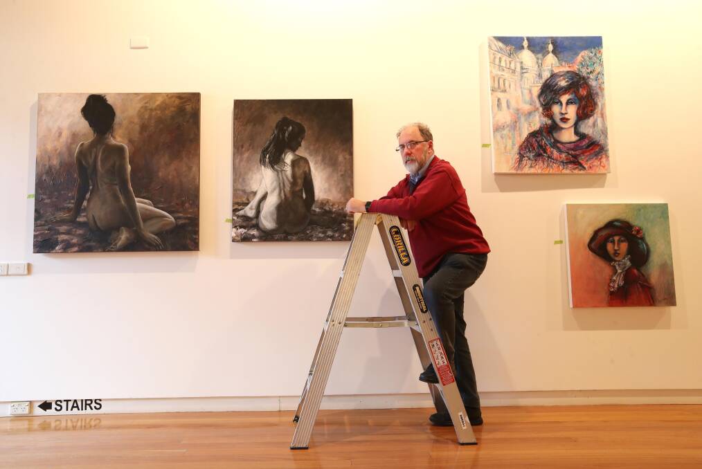 SOCIETY CELEBRATIONS: Geoff Fellows, secretary of the Wagga Art Society, spent Thursday afternoon hanging artworks for the 70th anniversary launch. Picture: Les Smith
