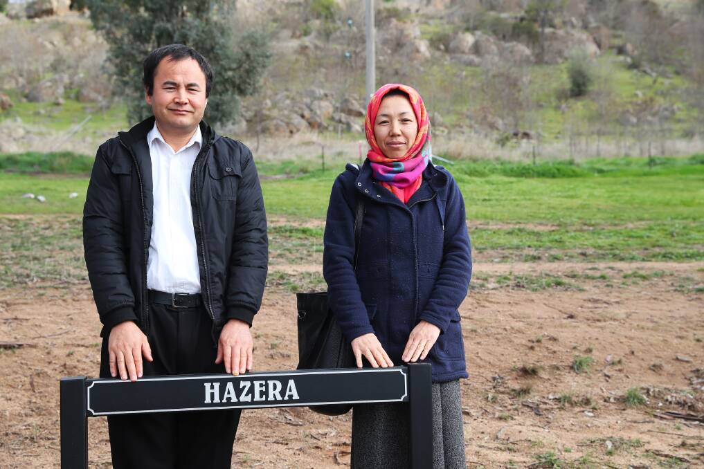 LAST RITES: Reza Zafari and Hakimah Rihimi at the burial site in the Monumental Cemetery. The sign has been incorrectly spelled, but Mr Zafari says this is a "minor detail" to be overlooked. Picture: Emma Hillier