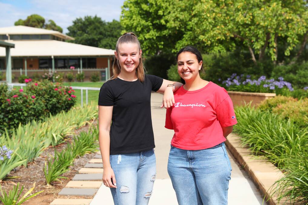 Cassie Sutton and Marina Gabra from The Riverina Anglican College congratulate each other on their HSC results. Picture: Emma Hillier