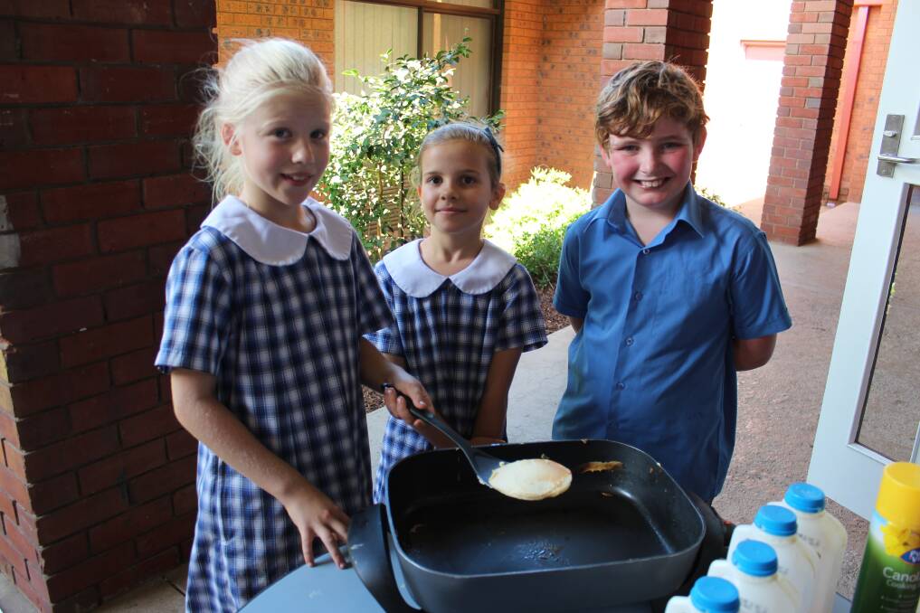 PANCAKE MAKERS: Violet Paton, Nicola Baaten and Andy Englefield, all aged 9, making pancakes for their classmates on Shrove Tuesday. Picture: Emma Horn