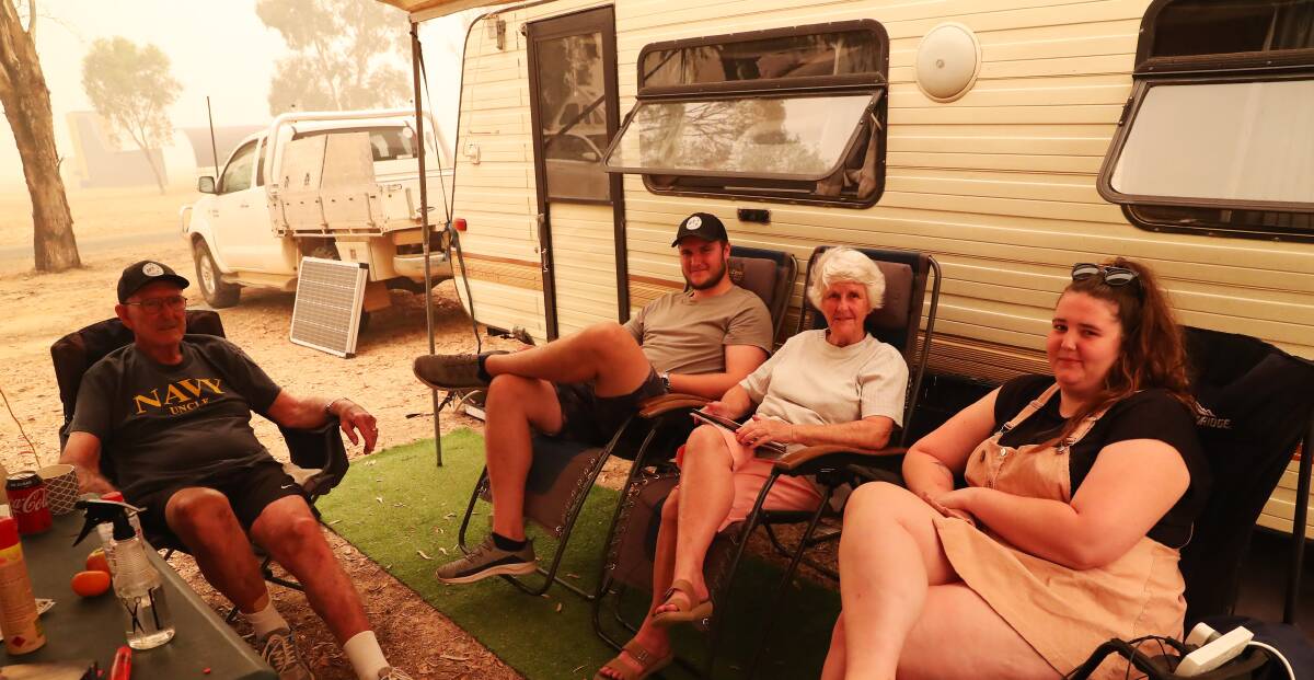 INSIDE THE SMOKE HAZE: Alan, Sam, Anne and Maddie Rudd from Batlow have no idea how long they will be living out of a caravan in Wagga. Picture: Emma Hillier