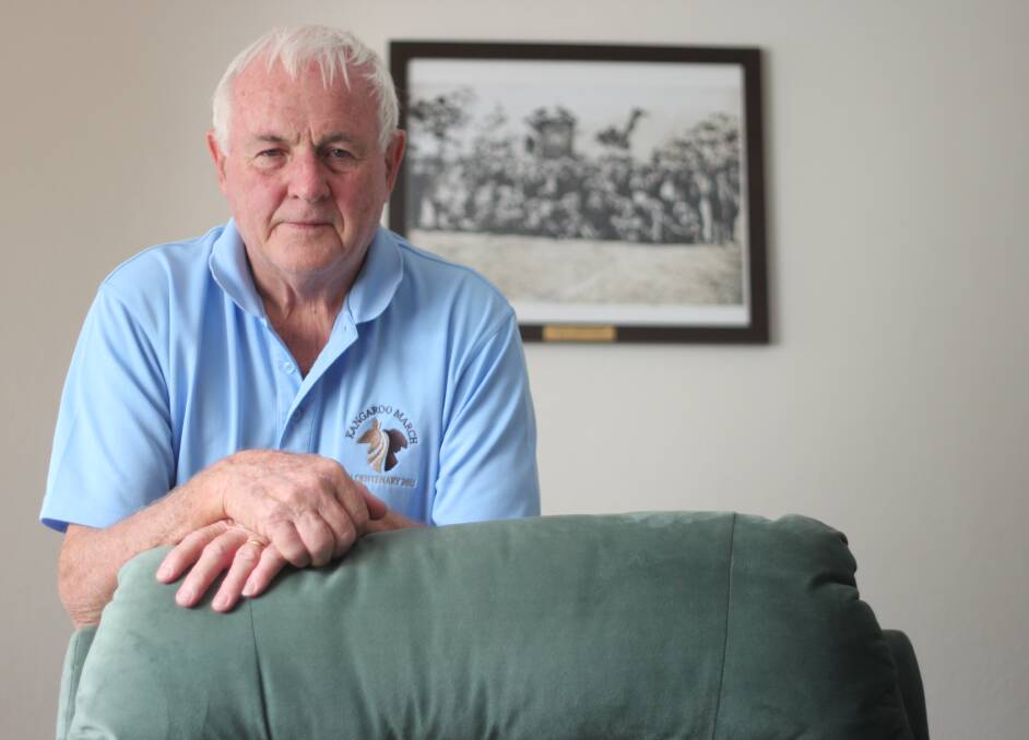 IN MEMORY: Since re-enacting the Kangaroo March, Michael Fitzgerald has come closer to his father's memory. Framed behind is a picture of the 96 men who joined the original Kangaroo March in 1915. Picture: Emma Horn