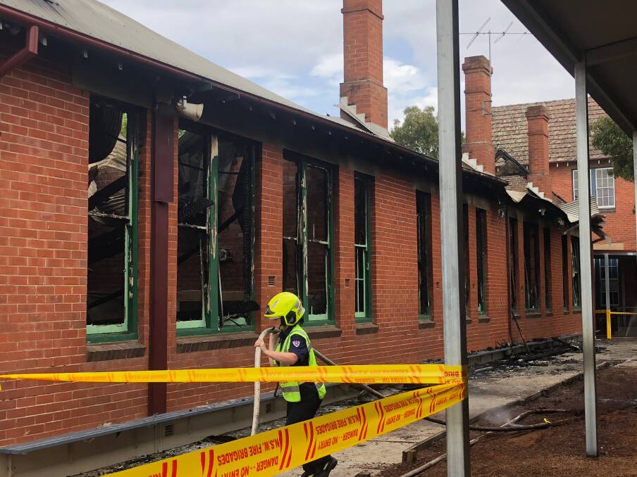 REPAIR AND REBUILD: Firefighters cordon off the fire-ravaged classrooms at Wagga Public School following the early morning blaze in January 2019.
