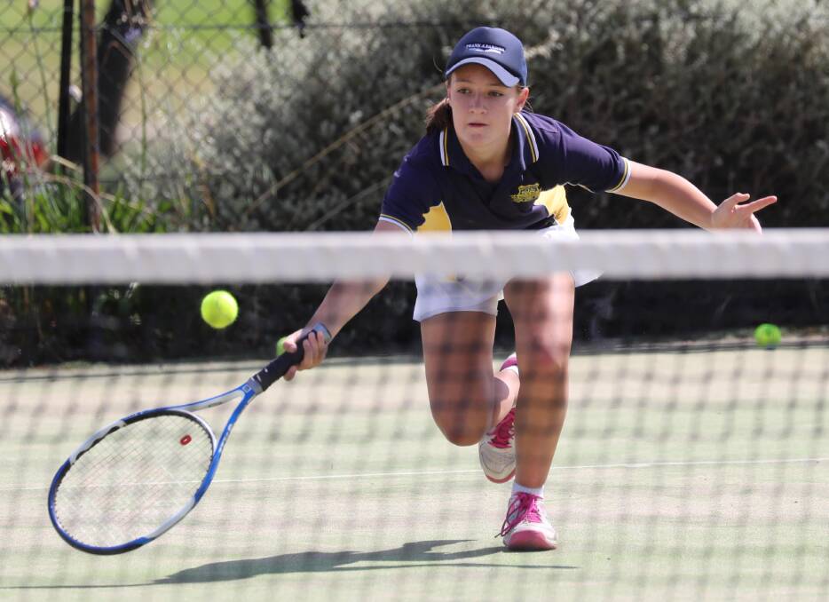 Mimi Russell aged 12, competes in the mixed doubles at last year's Kaitlin Staines Cup at Bolton Park.