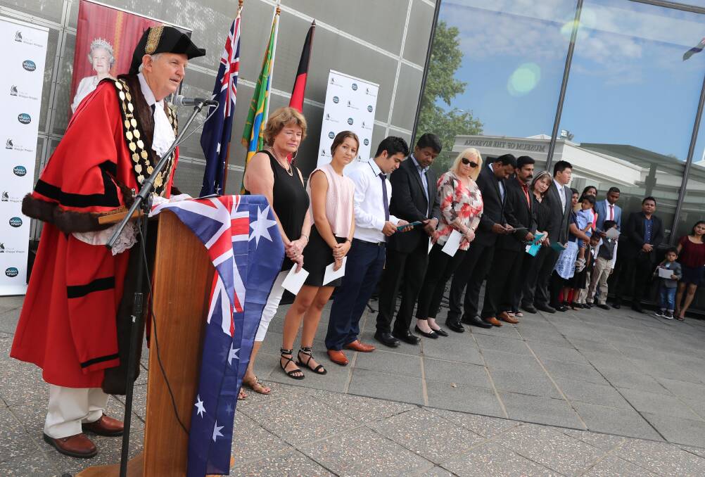 Wagga Mayor Greg Conkey performs a citizenship ceremony outside the council chambers last year. Picture: Les Smith