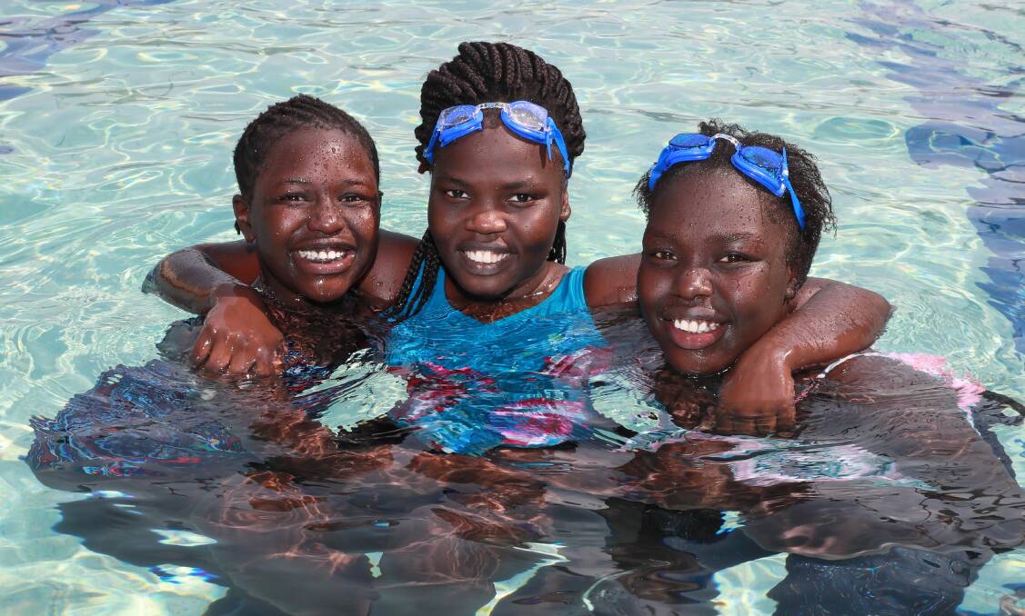 KEEPING COOL: Romia Hussein 10, Sara Angilo 21, and Rita Hussein 12, find a way to cool off during the 40-degree heat on Thursday. Picture: Les Smith