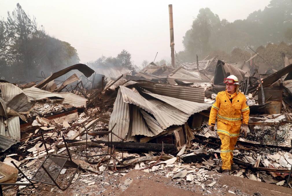 AFTERMATH: Chris Gibson with the Dareton FB (near Mildura) at the site of the old hospital in Batlow. Picture: Les Smith