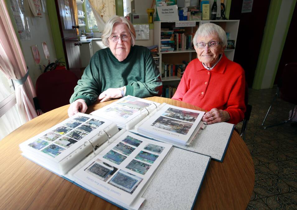 LABOUR OF LOVE: Helen Lubke and Noela Fox with some of the folders of soldiers' names that has been digitised. Picture: Les Smith