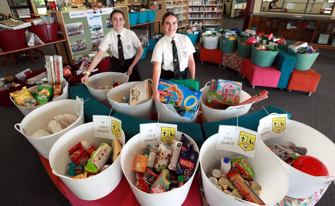 DONATION DRIVE: The Riverina Anglican College students Abigail Williams and Maddy Stout, both 16 spearheaded this year's Christmas hamper drive for Anglicare. Picture: Les Smith