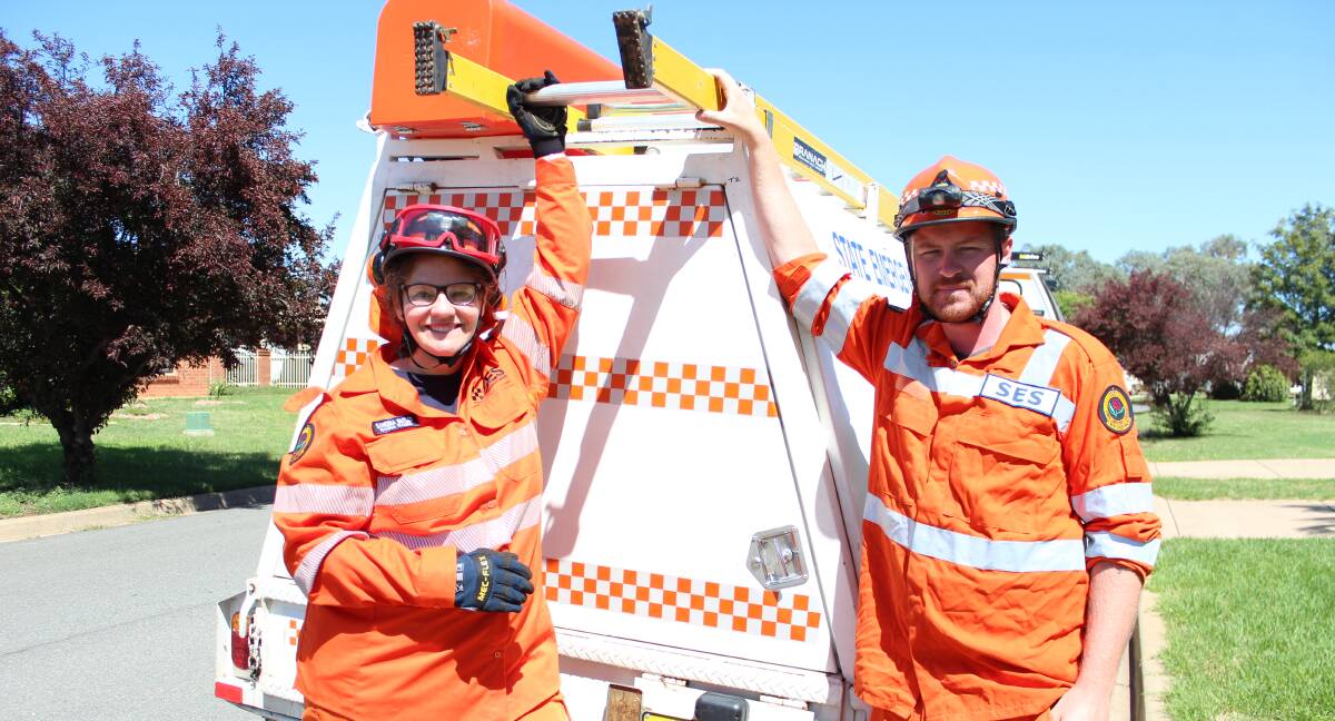 ORANGE HEROES: Volunteers Sandria Butler and Nathaniel Raine were among the team of SES mopping up after the storms rolled through Wagga and the Riverina on Friday. Picture: Emma Horn