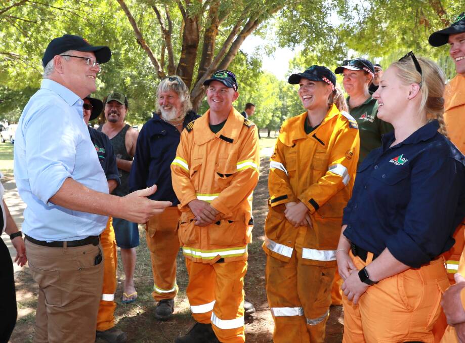 BUSHFIRE ANSWERS: Prime Minister Scott Morrison meets firefighters in Tumbarumba in January. Picture: Les Smith