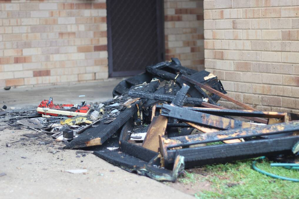 REMAINS: The burnt remains of a couch that was set alight outside the block of units on Bruce Street. Picture: Emma Horn
