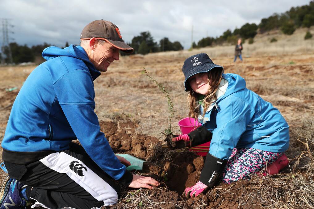 ALL NATURAL: Paul and 10-year-old Kate Burton plant a seedling to celebrate last year's National Tree Day. Picture: Emma Hillier