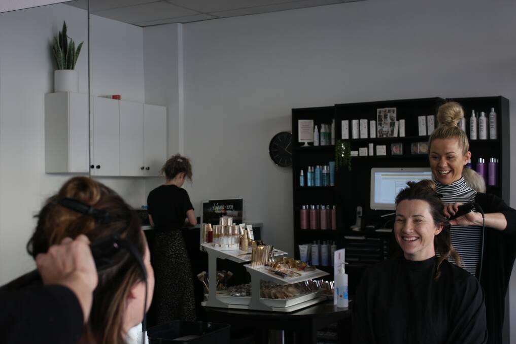 SLOW BUT STEADY: Stylist Katie Connellan does up Style Bar owner Alana Higgins at the Gurwood Street business. Picture: Emma Horn