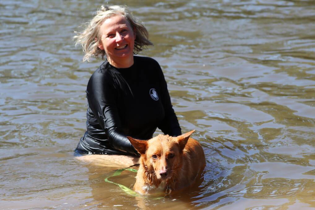 COOLING OFF: Christy Barnes and her dog Leif have a splash at Wagga Beach on Saturday. Picture: Emma Hillier