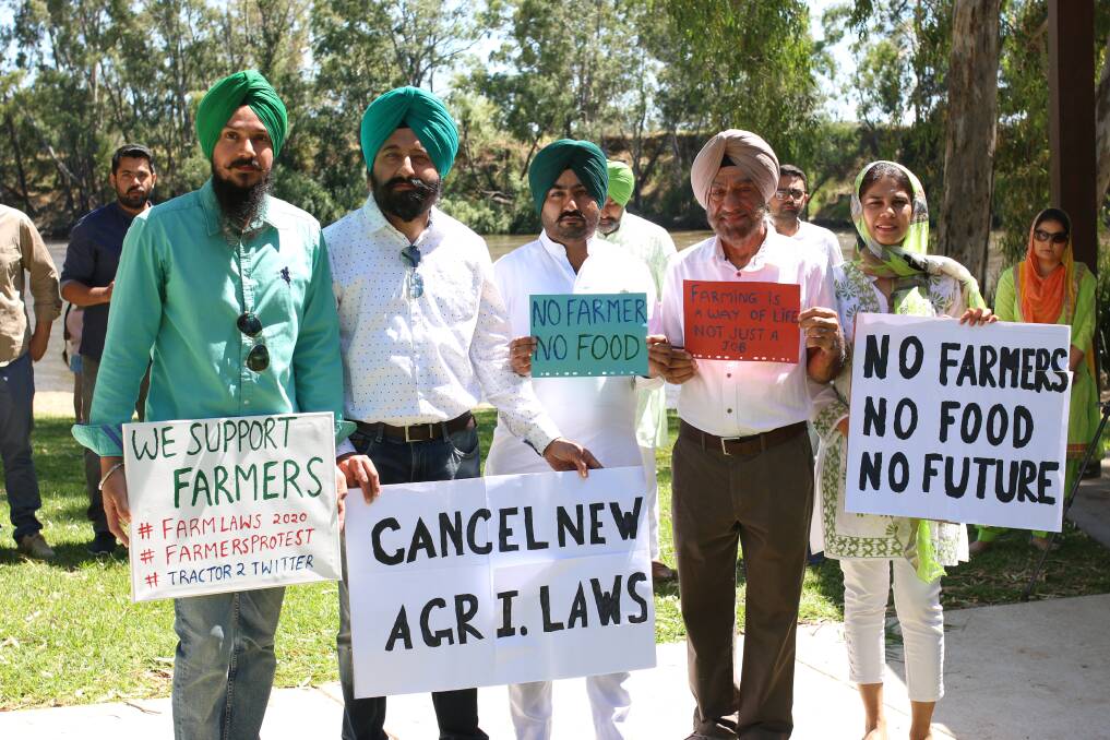 STANDING IN UNITY: Daman Uppal, Dr Aman Pasricha, Sarvjeet Singh, Dr Rajinder Singh and Dr Simrat Hayer with signs in solidarity for their family members in India