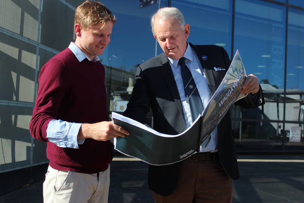 FACING THE FUTURE: City strategy manager Tristan Kell and mayor Greg Conkey survey the full report into the expansion of the health precinct. Picture: Emma Horn