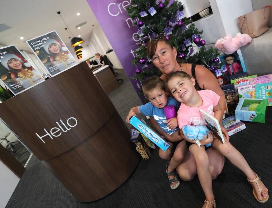 Nangus family Peta Zaric with four-year-old twins Cody and Bree Wheeler at the launch of this year's Country Hope Christmas gift appeal. Picture: Les Smith