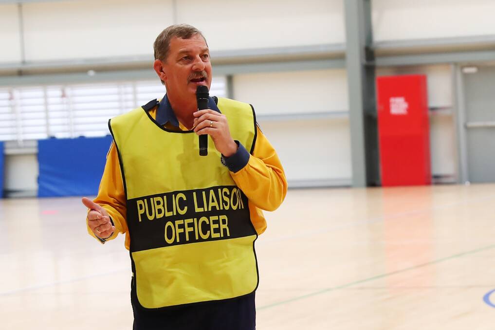 TOWN MEETING: RFS representative Peter Jones provides updates to the evacuated communities of Adelong, Talbingo, Tumbarumba and Batlow during a meeting at Wagga's Equex Centre. Picture: Emma Hillier