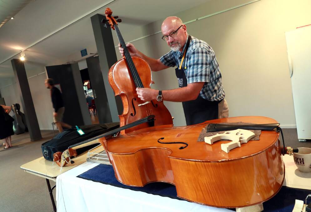 MAKING MUSIC: Peter Reid from Orange has been crafting stringed instruments by hand for the past 20 years, and has been on-hand in Wagga for any emergency on-the-spot repairs. Picture: Les Smith