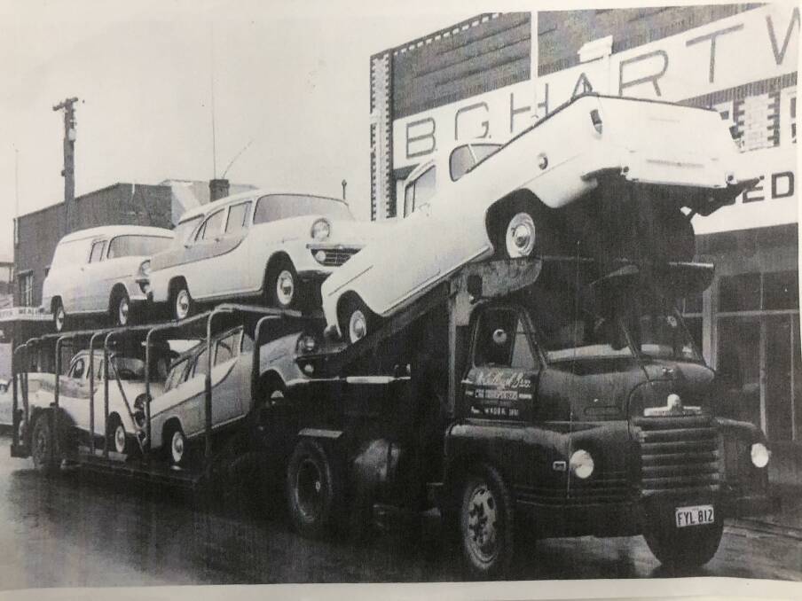 DRIVING BACK IN TIME: Neville McCoullough believes he may be behind the wheel of the car-carrying truck in this photo from circa 1961. The carrier is transporting a load of Holden FBs to Hartwig's Holdens, then on Baylis Street.