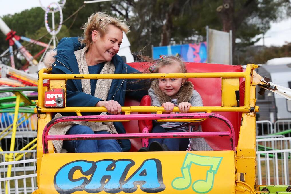 SHOW TIMES: Cathy Parmenter and Lily Hoey aged 5, take a ride on the Cha-Cha. Picture: Emma Hillier
