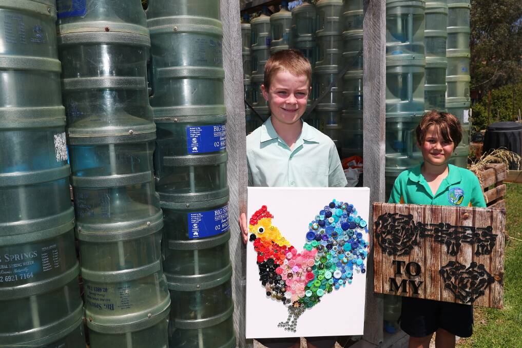 UNDER THE HAMMER: Billie Burns, 11, and Harry Richards, 9, with the artworks their classes made out of recycled goods, which will be auctioned at Saturday's fete. Picture: Emma Hillier