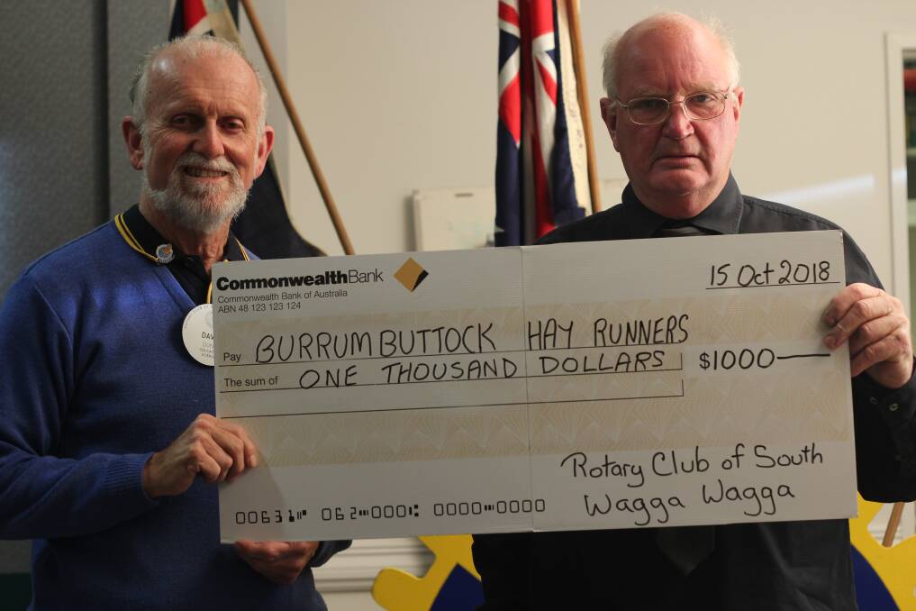 DROUGHT SUPPORT: President of the Wagga Rotary Club David Dunn presents the cheque to Wagga businessman and farmer Ian Haig. Picture: Emma Horn