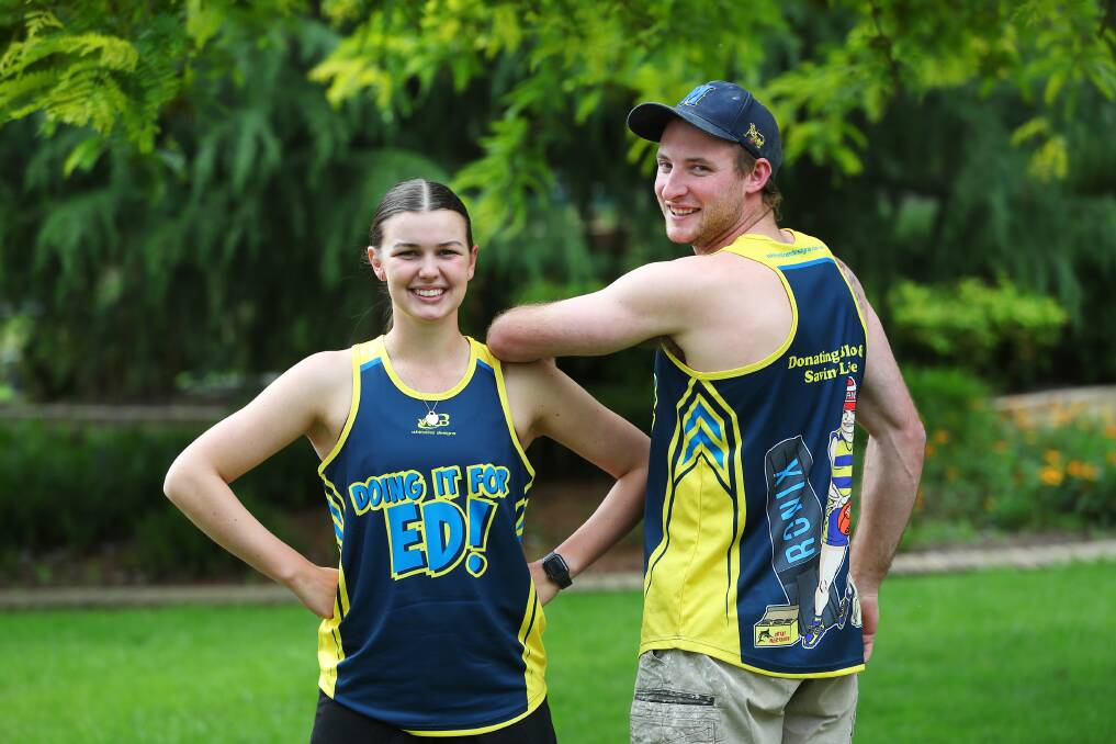 FRIENDS OF ED: Sara Langfield and Jesse Cunningham in their 'Doing It For Ed' singlets ahead of this Saturday's fundraiser for leukaemia sufferer Edward Moloney. Picture: Emma Hillier