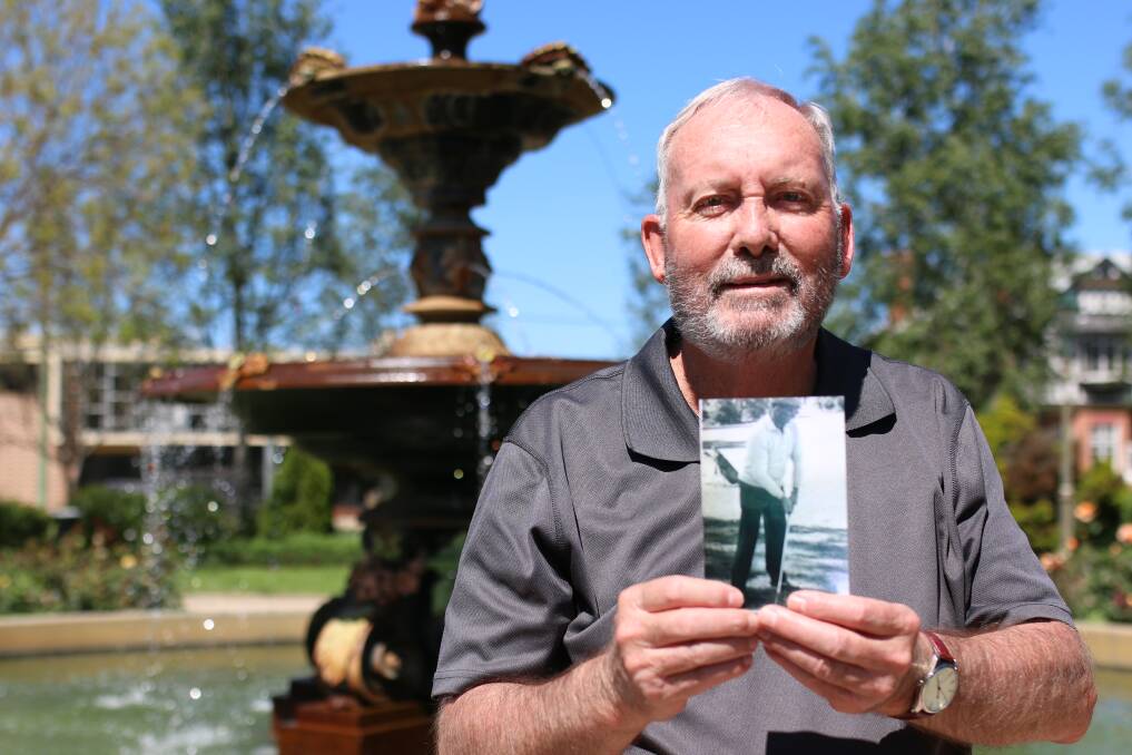 IN HIS MEMORY: Jack Mooney's son, Pat, holds a picture of his late father putting at the Junee Golf Course. Picture: Emma Horn