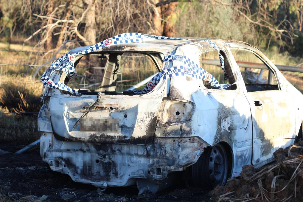 The burnt out Daihatsu Charade found near the rail bridge on Red Hill Road, Lloyd. Picture: Emma Horn