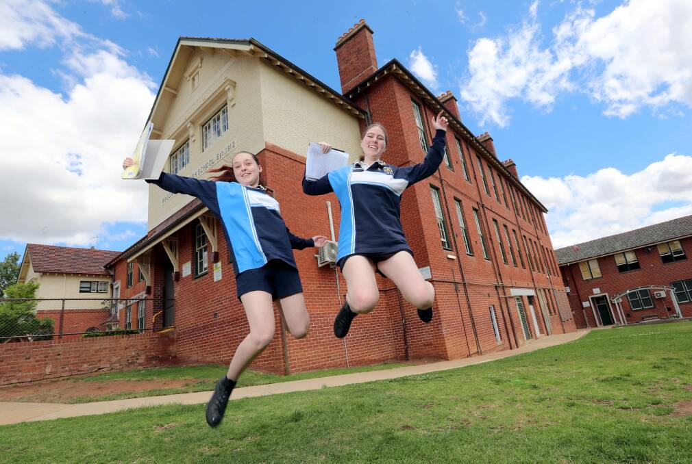 ALL DONE: Wagga High School students Makenna Lucas and Matilda O'Connor jumped for joy after completing their HSC in 2018.