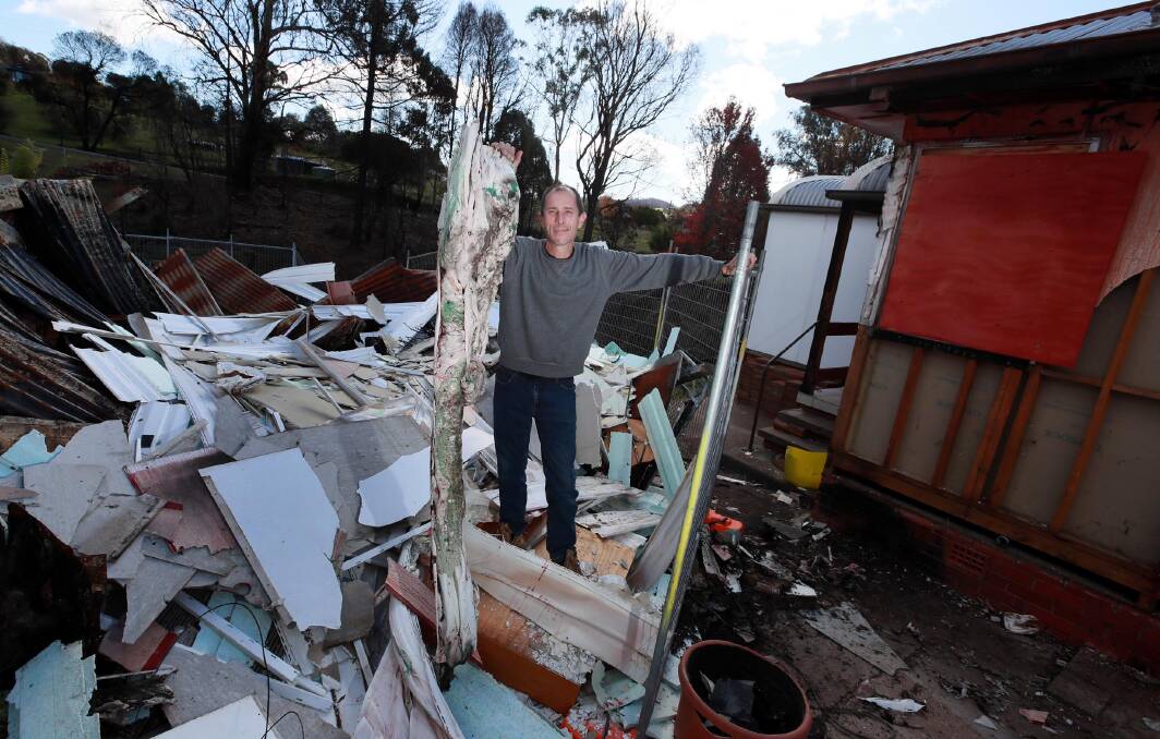 WHAT REMAINS: Dean Sweeney was fortunate that most of his house still stands, but with melted cladding and a destroyed shed, he has faced a long clean-up. Picture: Les Smith
