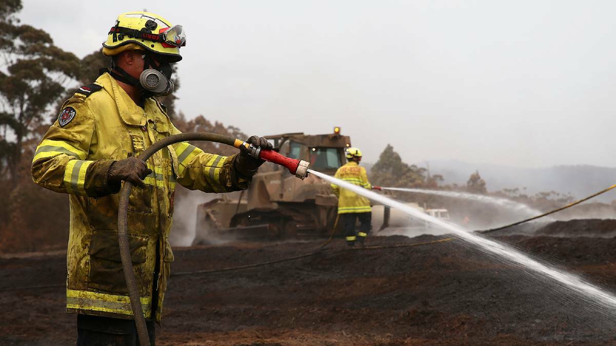 FIRE STOCK: NSW Fire and Rescue officers have been working to contain the fire at the Eden Chip Mill for the past 10 days. Across the state, the fires have caused enormous supply problems for hard and soft woods. Picture: Sgt Max Bree
