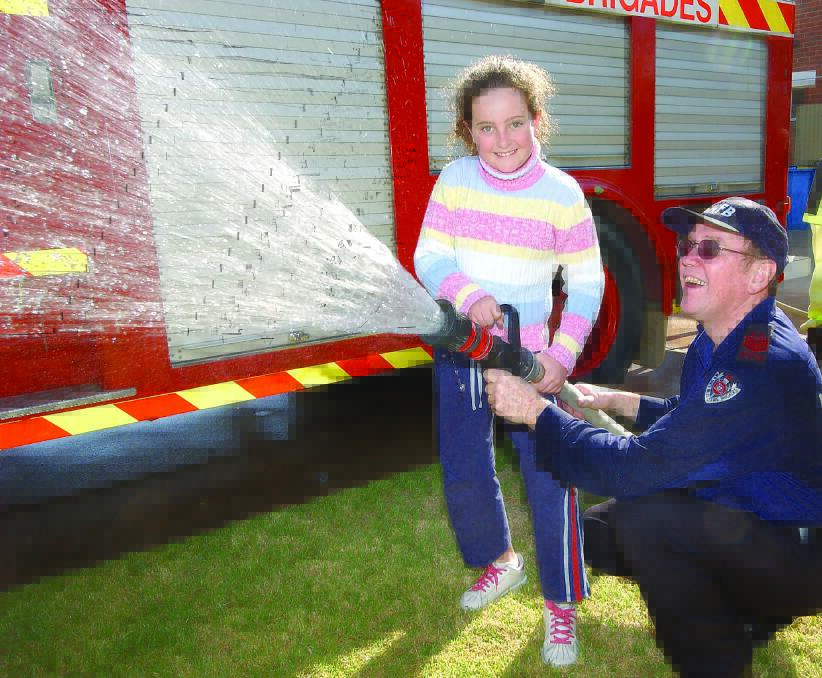 FRNSW Turvey Park Deputy Captain David Gill with eight-year-old Jade Campbell at the station open day in 2004. File image