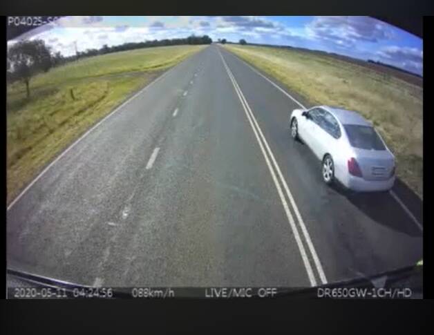 'I'M SORRY': Dashcam footage shows the moment a sedan passes a truck across unbroken lines near Darlington Point.