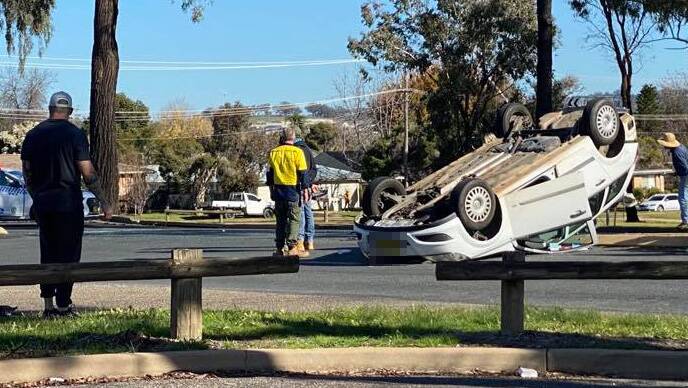 A woman was taken to hospital with head injuries after a car flipped on Bourke Street. Picture: Daina Oliver