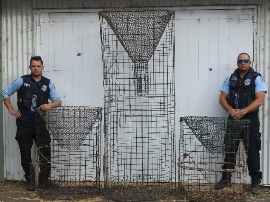 NSW Fisheries staff with illegal nets pulled from the Lachlan River around Hillston. Picture: NSW DPI Fisheries